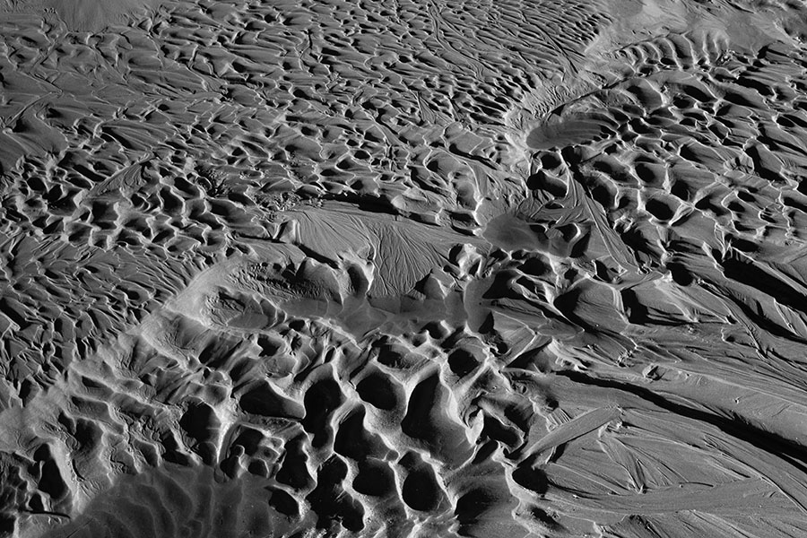 High Contrast Infrared Photo of Ripples in Wet Beach Sand.